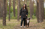 woman and Miniature Australian Shepherd