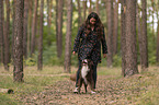 woman and Miniature Australian Shepherd