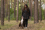 woman and Miniature Australian Shepherd