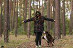 woman and Miniature Australian Shepherd