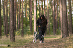 woman and Miniature Australian Shepherd