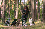 woman and Miniature Australian Shepherds