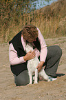 woman snuggles with Parson Russell Terrier