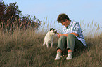 woman feeds Parson Russell Terrier