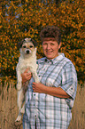 woman carries Parson Russell Terrier