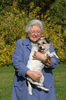 woman carries Parson Russell Terrier