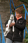 woman is carriing a Parson Russell Terrier