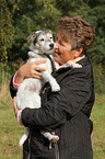 woman carries a Parson Russell Terrier