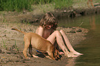 boy with Rhodesian Ridgeback puppy