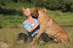 woman snuggles with Rhodesian Ridgeback
