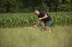 man with Rhodesian Ridgebacks