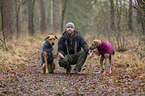 man and 2 Rhodesian Ridgebacks