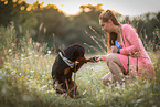 woman and young Rottweiler