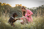 woman and young Rottweiler