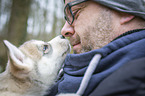 man with Siberian Husky puppy