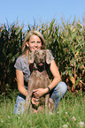 woman and shorthaired Weimaraner
