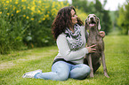 woman and shorthaired Weimaraner