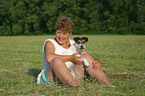 woman with dog in the meadow