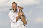 man with Miniature-Pinscher-Dachshund-Mongrel