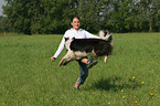 dog jumps over leg