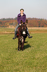 woman rides donkey