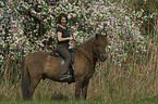 woman rides pony