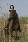 woman rides pony