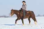 man rides American Paint Horse