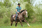 man rides American Paint Horse