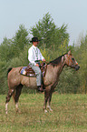 man rides American Paint Horse