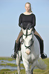 woman rides Andalusian horse