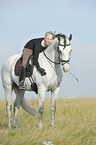 woman rides Andalusian horse