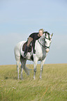 woman rides Andalusian horse