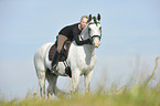 woman rides Andalusian horse