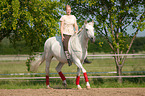 woman rides Andalusian horse