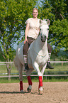 woman rides Andalusian horse