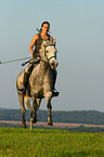 woman rides arabian horse