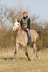 woman rides arabian horse