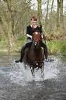 woman rides arabian horse