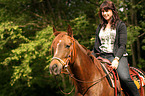 woman rides arabian horse