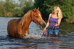 woman with arabian horse in the lake