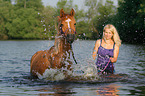 woman with arabian horse in the lake