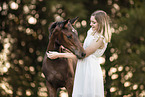 woman and Austrian warmblood foal