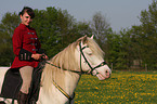 woman rides Connemara-Pony