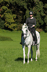 woman rides english thoroughbred