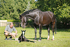 man with newborn foal