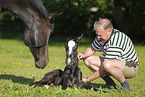 man with newborn foal