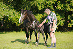 man with newborn foal