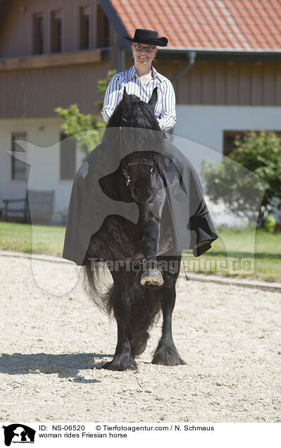 woman rides Friesian horse / NS-06520