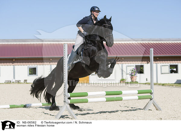 woman rides Friesian horse / NS-06582